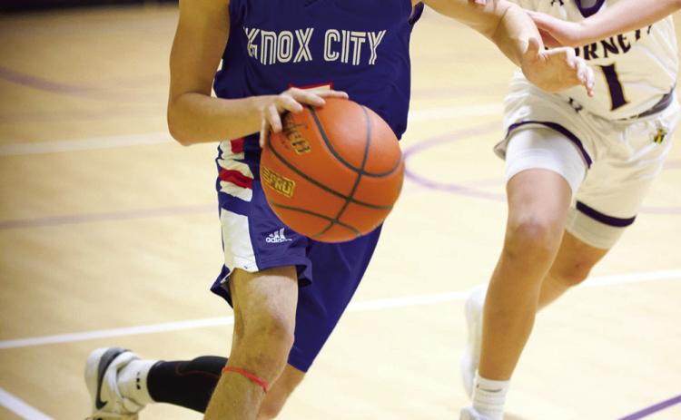 Jerry Grayson pushes his way down the court despite the defensive pressure. | SHERI BATY PHOTO