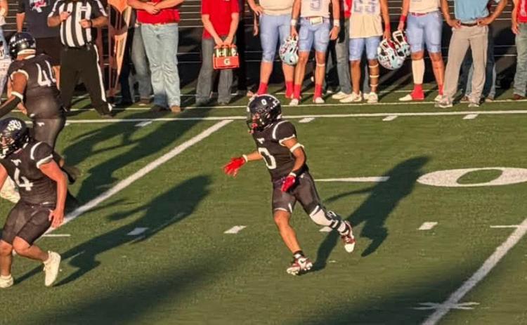 LOOKING AHEAD The Mustang spreadback looks for someplace to run as the Borden County Coyotes rush to a 66-16 win over Benjmain on their home field. | COURTESY PHOTO