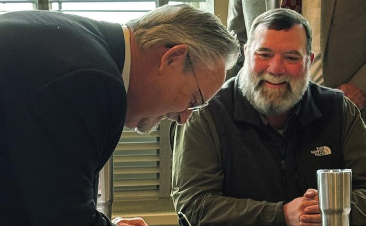 BOND OF OFFICE Don Thompson of Munday (left) signed the surety bond required to serve the unexpired term of county judge on Dec. 6, as Judge Stan Wojcik and commissioners look on. | NEWS-COURIER