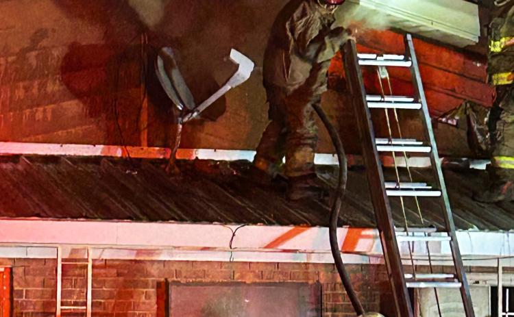 NOWAY IN In the early going Saturday night, Knox City firefighters searched for a way into the attic of the 1968 Knox City Country Club buidling, fighting thick smoke that obscured the flames raging inside the attic. | NEWS-COURIER
