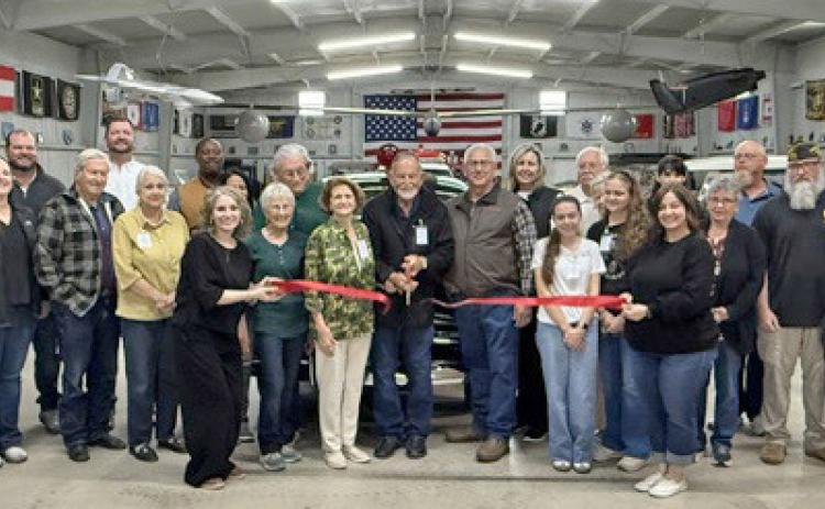 NEW MUSEUM FOR OLD VEHICLES Sam Baker cut the ribbon at the grand opening of the new location of Fort Sam Military and Antique Vehicle Museum of Haskell County, surrounded by the museum’s board of directors, spouses, family members, staff, Haskell Chamber of Commerce members, volunteers and members of the VFW Post 9179 of Stamford. | COURTESY PHOTO