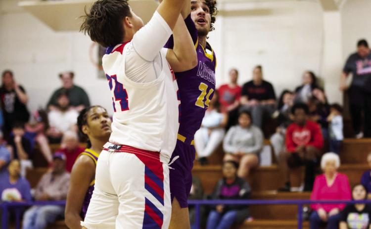 MOGULS WIN Chase Rowland reaches for the net but is met by Munday's Mance Phillips | SHERI BATY PHOTO