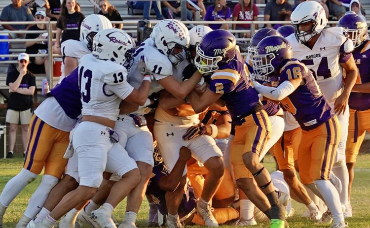 MASS OF MOGULS converged on a Roscoe running back and prevailed—eventually—over the Plowboys in Munday’s Homecoming football game Sept. 11. With both teams scoreless going into the second half, Munday broke things open to claim the win, 21–0. | LACI BOWMAN PHOTO