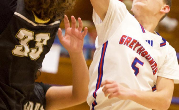 UP FORTHE REBOUND Bently Stroud goes up for the rebound in last week’s Hounds win 52-- 29 against Woodson. | SHERI BATY PHOTO