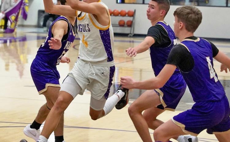 THROUGH THE LANE Carson Willison drives through the lane surrounded by Hornets. | LACI BOWMAN PHOTO