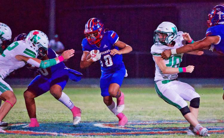 THROUGHTHE OPENING Hunter Lerma finds the hole and runs through the Newcastle defense in what ultimately results in a heartbreaking Greyhound loss. | SHERI BATY PHOTO