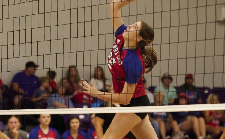 Grayson Utley attacks the ball at the net. | SHERI BATY PHOTO