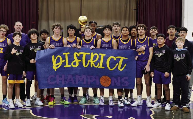 MIGHTY MOGULS The Munday boys sealed their district basketball championship Tuesday night with a perfect record, 11-0. | LACI BOWMAN PHOTO